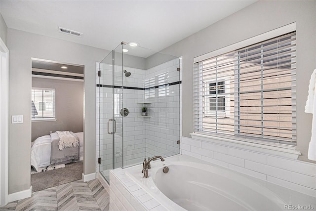 1011 White Leaf Cir, Castle Rock, CO 80108 - ensuite bathroom featuring a shower stall, a garden tub, baseboards, and recessed lighting
