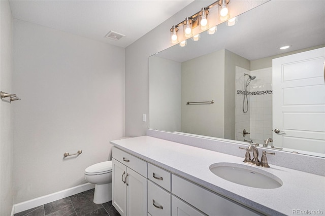 1011 White Leaf Cir, Castle Rock, CO 80108 - bathroom with baseboards, a tile shower, toilet, vanity, and tile patterned flooring