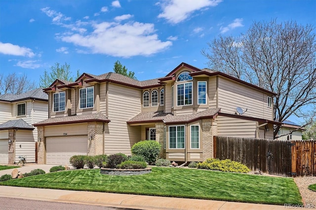 7354 S Robb St, Littleton, CO 80127 - view of front of home featuring brick siding, a garage, driveway, and roof with shingles