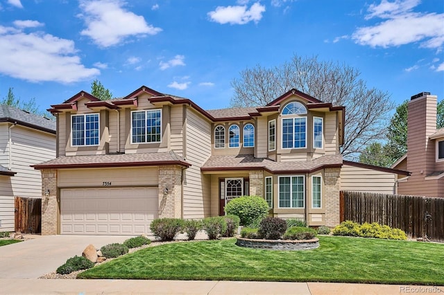 7354 S Robb St, Littleton, CO 80127 - view of front facade with brick siding, concrete driveway, and a garage