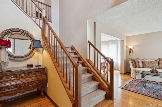 7354 S Robb St, Littleton, CO 80127 - staircase with wood finished floors and a textured ceiling