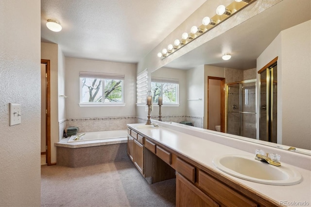 7354 S Robb St, Littleton, CO 80127 - bathroom featuring a stall shower, double vanity, and a garden tub