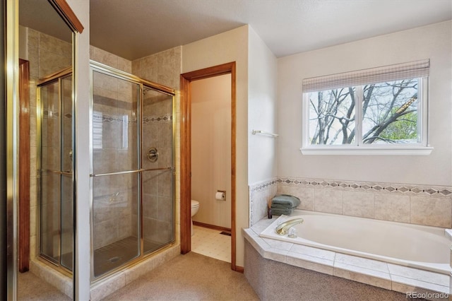 7354 S Robb St, Littleton, CO 80127 - bathroom featuring a shower stall, toilet, a garden tub, and baseboards