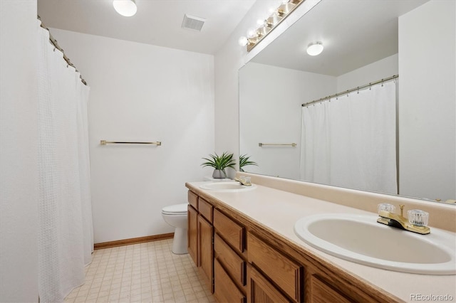 7354 S Robb St, Littleton, CO 80127 - bathroom featuring tile patterned floors, toilet, double vanity, and baseboards