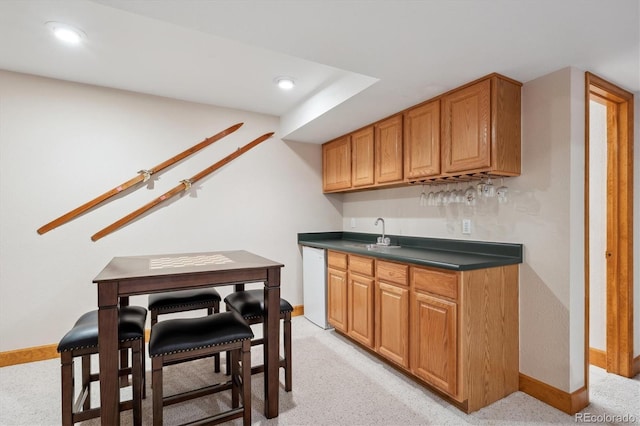 7354 S Robb St, Littleton, CO 80127 - indoor wet bar featuring white dishwasher, light carpet, baseboards, and recessed lighting