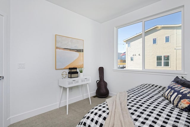 bedroom with carpet flooring and baseboards