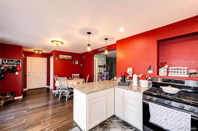 1824 Asoka St, Strasburg, CO 80136 - kitchen with gas range, white cabinetry, a peninsula, light stone countertops, and pendant lighting