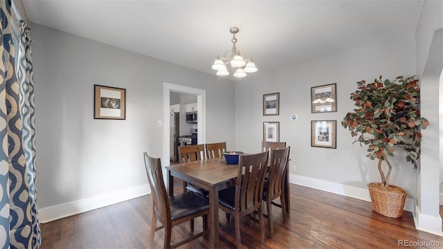 dining room featuring dark hardwood / wood-style floors and a notable chandelier