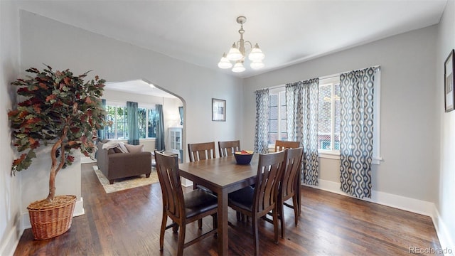 dining space featuring dark hardwood / wood-style floors and a notable chandelier