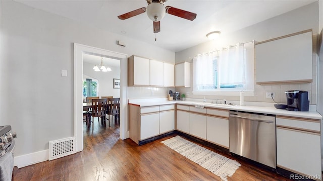 kitchen featuring white cabinetry, stainless steel dishwasher, tasteful backsplash, and dark wood-type flooring