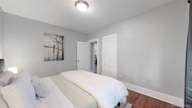 bedroom with dark wood-type flooring