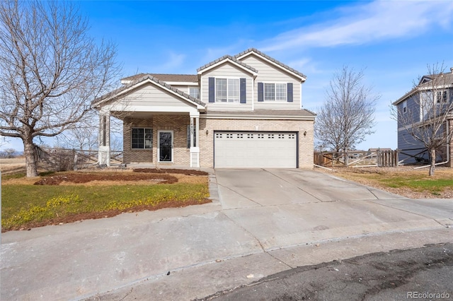 view of front of property with a garage, concrete driveway, brick siding, and fence