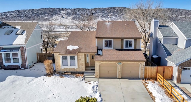 view of front of house with a mountain view and a garage