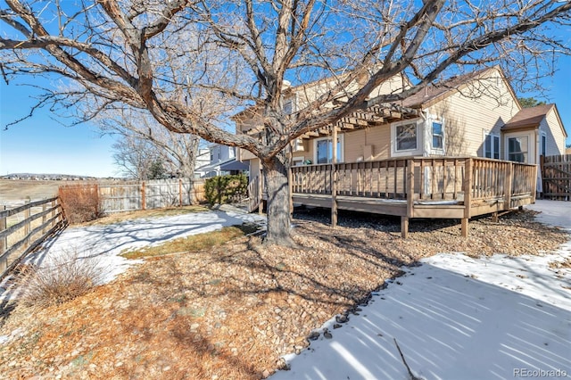 yard layered in snow featuring a wooden deck