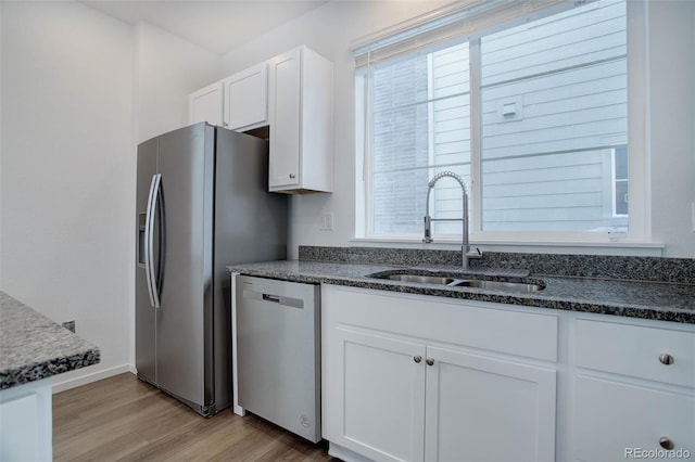 23670 E 41 St Ave, Aurora, CO 80019 - kitchen with appliances with stainless steel finishes, white cabinetry, light wood-style flooring, and plenty of natural light