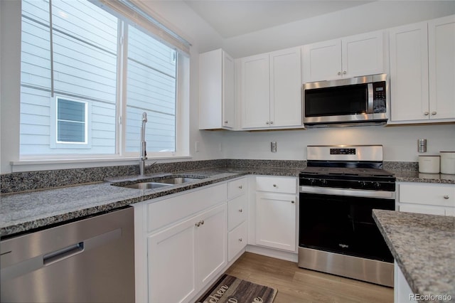 23670 E 41 St Ave, Aurora, CO 80019 - kitchen featuring appliances with stainless steel finishes, white cabinetry, and dark stone counters