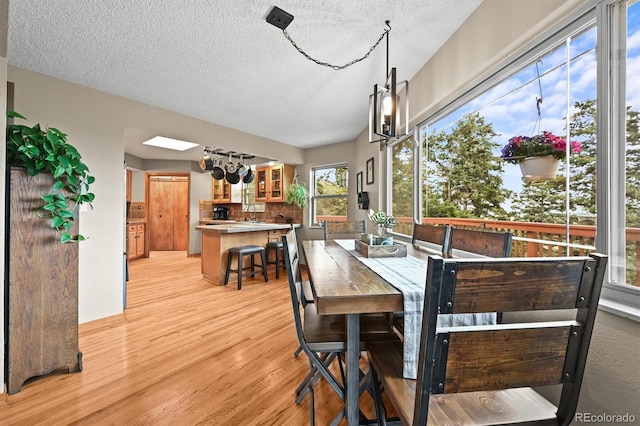 13540 Deer Ridge Way, Larkspur, CO 80118 - dining space with light wood-style floors and a textured ceiling