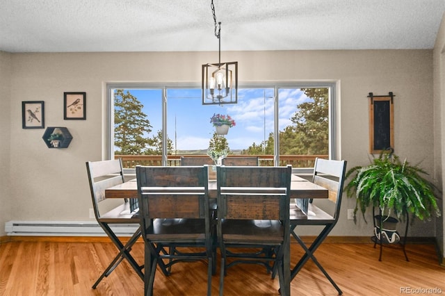 13540 Deer Ridge Way, Larkspur, CO 80118 - dining area featuring wood finished floors, a chandelier, and a textured ceiling