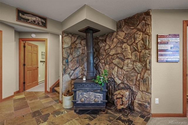 13540 Deer Ridge Way, Larkspur, CO 80118 - detailed view of a wood stove and a baseboard heating unit