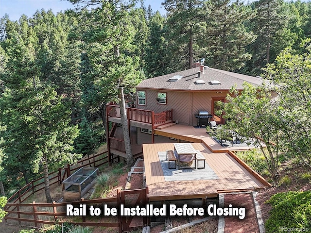13540 Deer Ridge Way, Larkspur, CO 80118 - rear view of property with a deck and a forest view