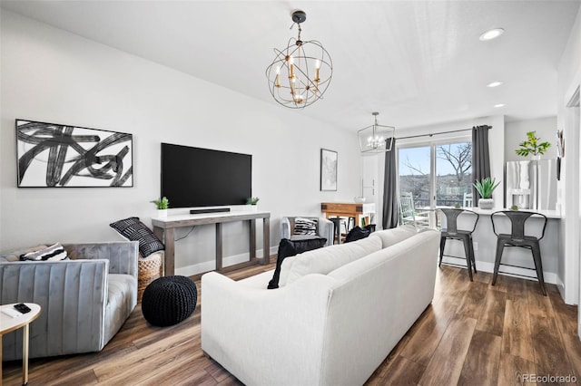 living room featuring an inviting chandelier and hardwood / wood-style floors