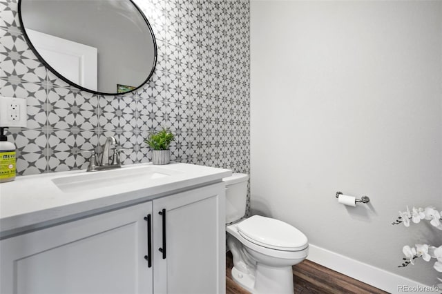 bathroom with tile walls, hardwood / wood-style floors, vanity, and toilet