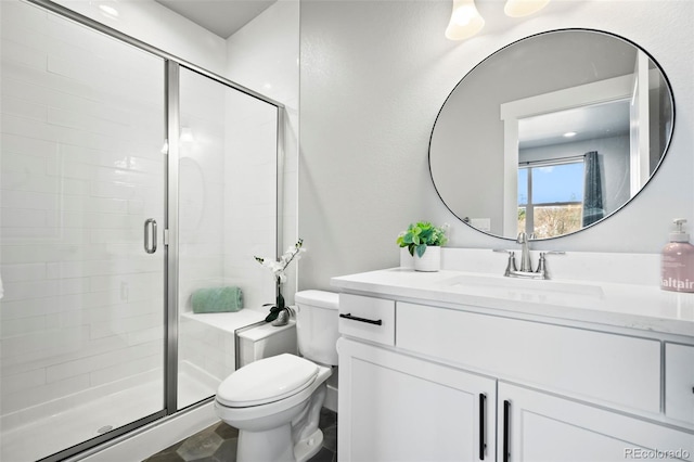 bathroom featuring walk in shower, vanity, and toilet