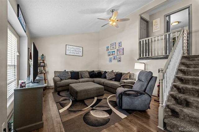 11323 Albion St, Thornton, CO 80233 - living area with vaulted ceiling, wood finished floors, a ceiling fan, a textured ceiling, and stairs