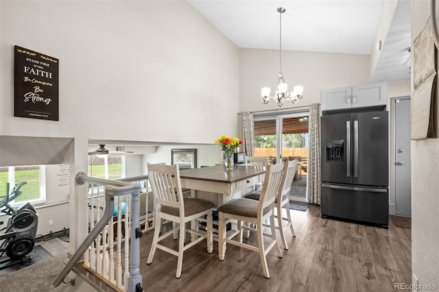 11323 Albion St, Thornton, CO 80233 - dining space featuring high vaulted ceiling, a chandelier, wood finished floors, and plenty of natural light