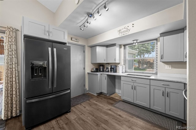 11323 Albion St, Thornton, CO 80233 - kitchen featuring fridge with ice dispenser, dark wood-style floors, light countertops, and gray cabinetry