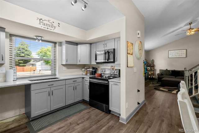 11323 Albion St, Thornton, CO 80233 - kitchen with black range with electric cooktop, stainless steel microwave, light countertops, gray cabinets, and open floor plan