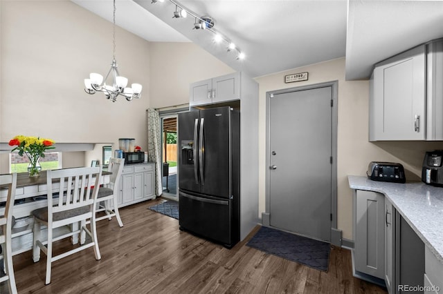 11323 Albion St, Thornton, CO 80233 - kitchen featuring fridge with ice dispenser, a chandelier, black microwave, dark wood-style floors, and high vaulted ceiling
