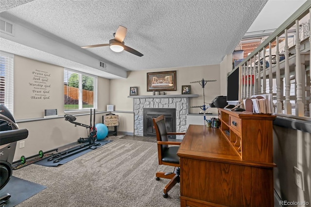 11323 Albion St, Thornton, CO 80233 - carpeted office space featuring a ceiling fan, a textured ceiling, and a fireplace