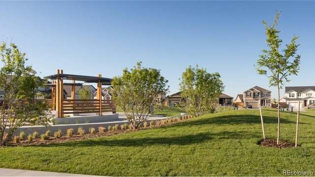 view of community featuring a yard and a residential view