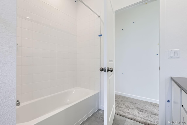 bathroom with shower / tub combination, tile patterned flooring, and baseboards