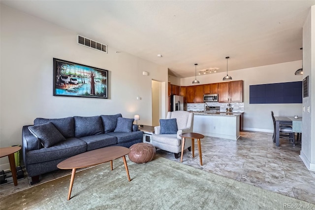 living room with visible vents and baseboards