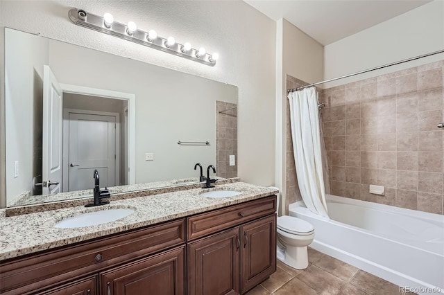 full bath with double vanity, a sink, shower / bath combo with shower curtain, and tile patterned floors