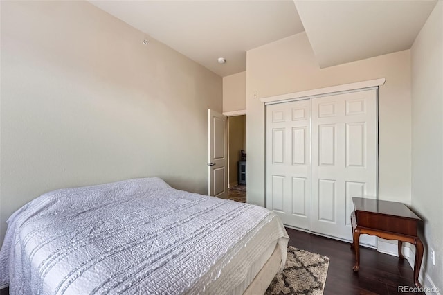 bedroom featuring a closet and dark wood-type flooring