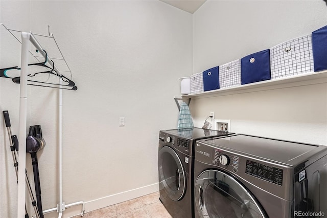 laundry room with tile patterned floors, laundry area, baseboards, and separate washer and dryer