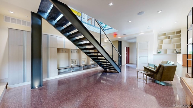 interior space with a skylight and built in shelves