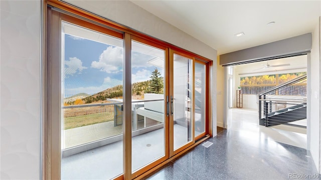 doorway featuring ceiling fan