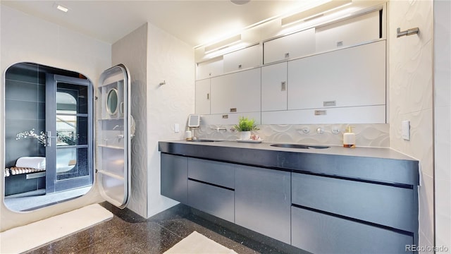 bathroom featuring vanity and decorative backsplash