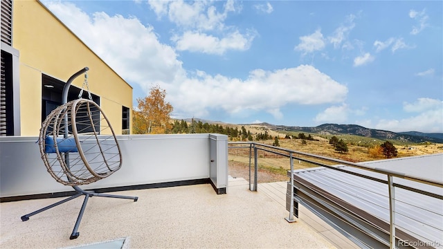 view of patio / terrace with a mountain view and a balcony