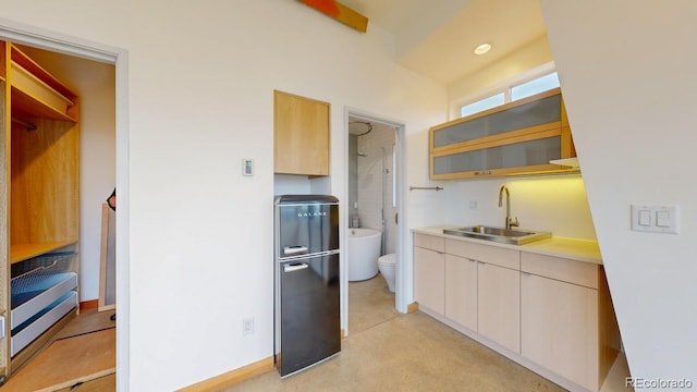 kitchen with sink and black refrigerator