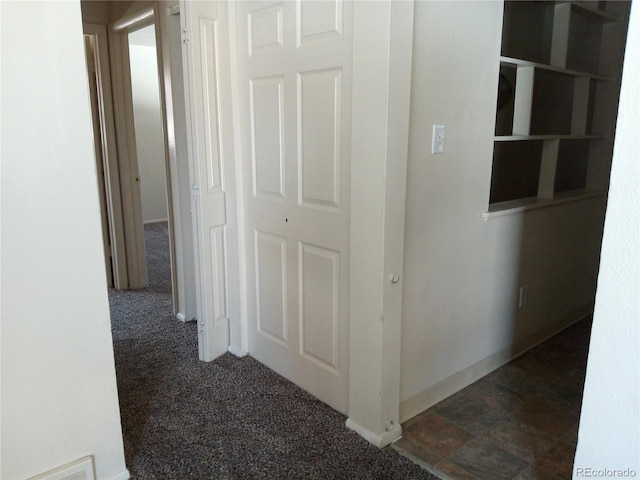 corridor with dark colored carpet