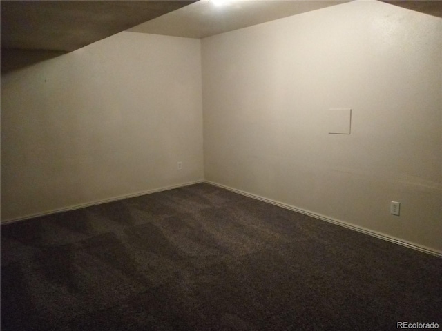 empty room featuring dark colored carpet