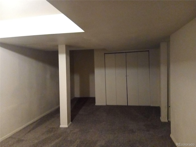 basement with dark colored carpet