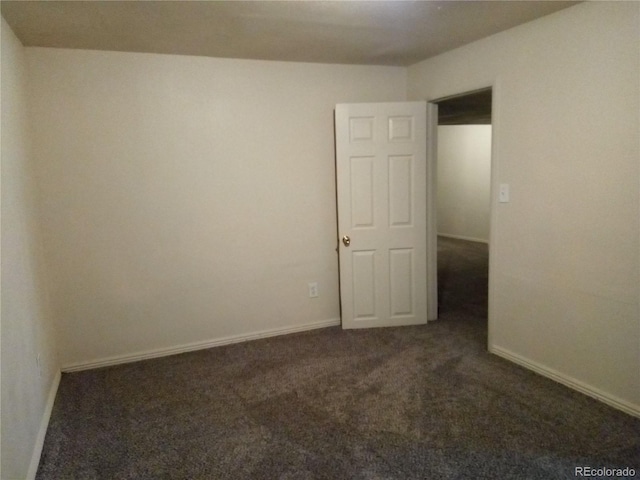 empty room featuring dark carpet