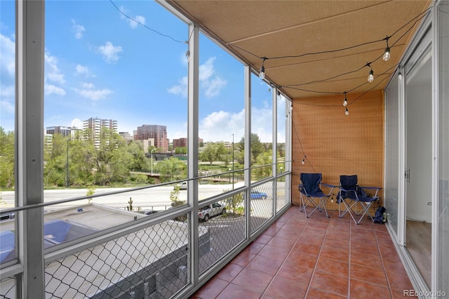 sunroom featuring a city view