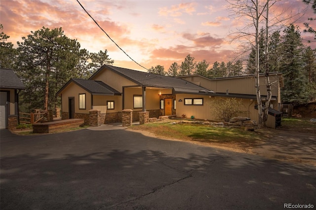 32173 Soda Creek Dr, Evergreen, CO 80439 - view of front facade with stone siding and asphalt driveway